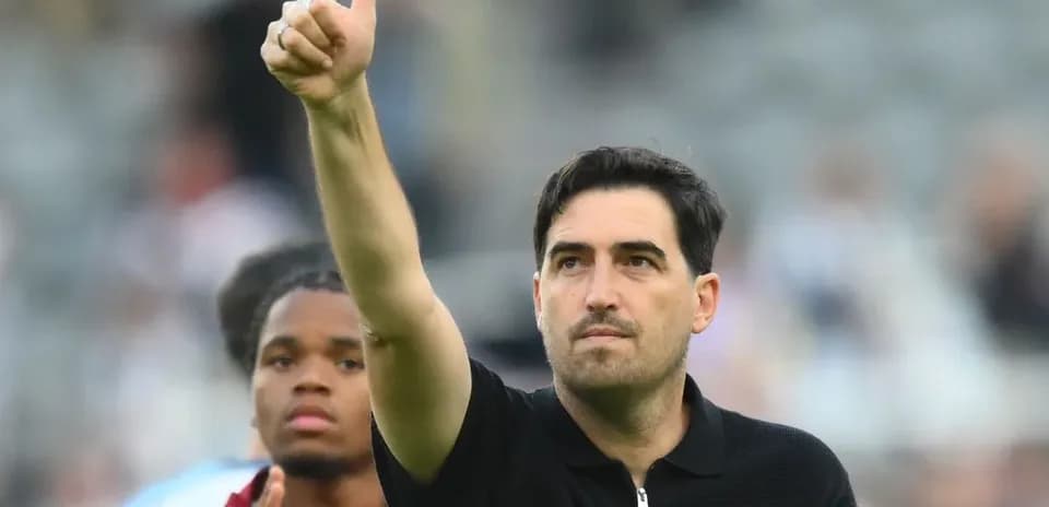 Coach giving thumbs up gesture after match