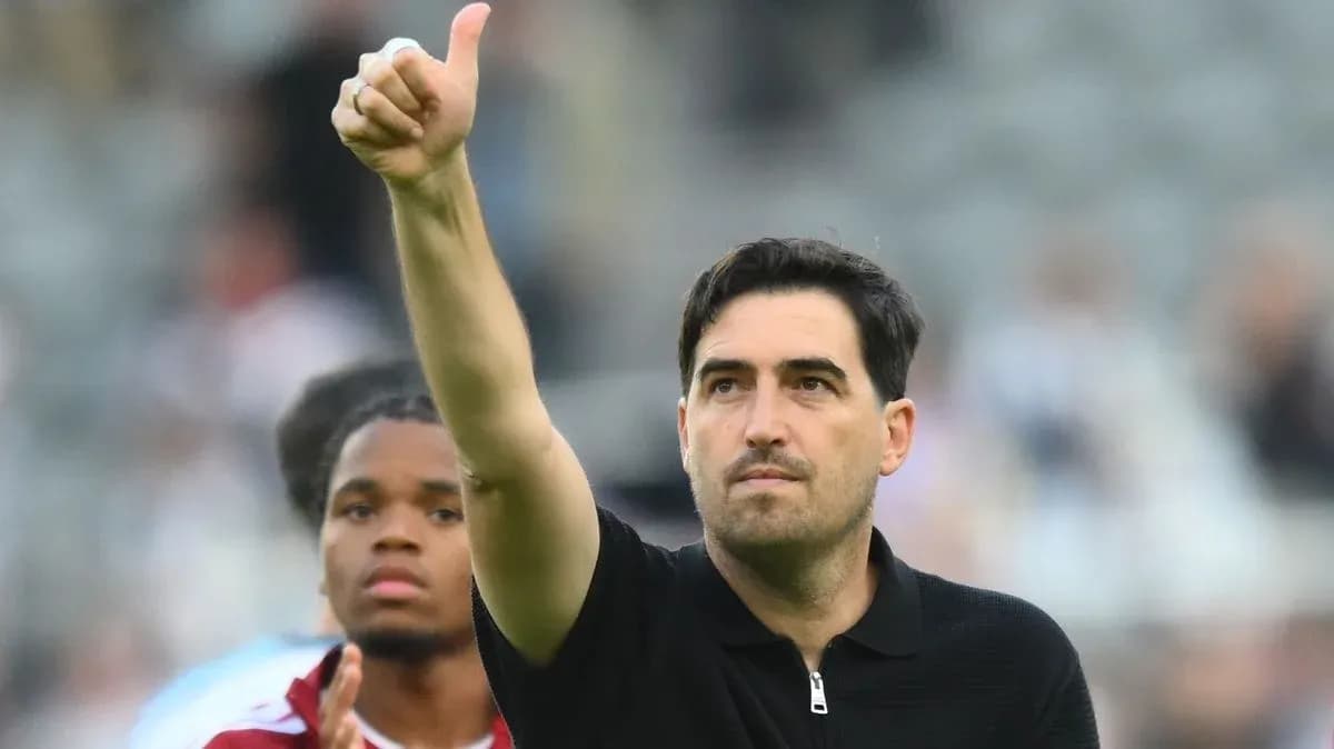 Coach giving thumbs up gesture after match