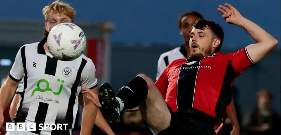 Player attempting to control ball during match action