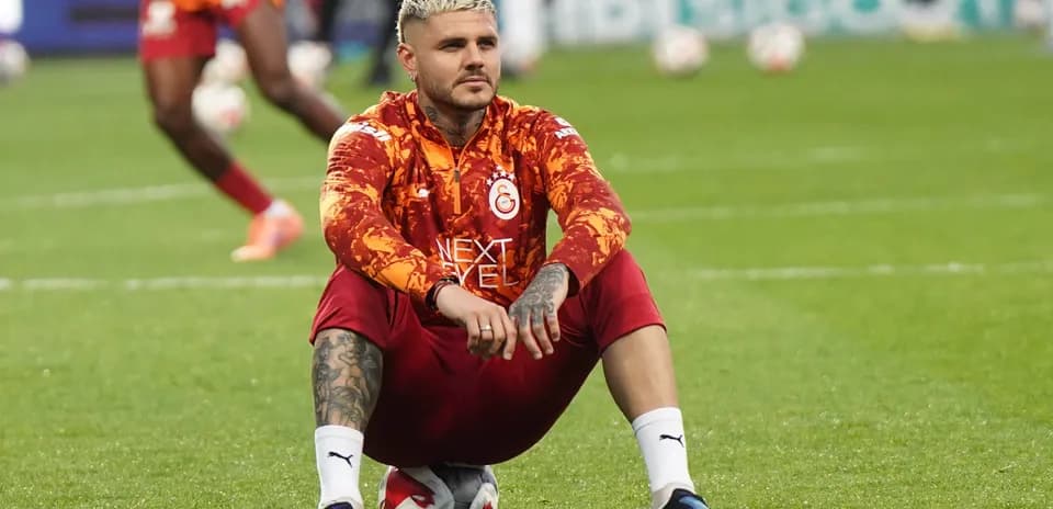 Futbolçu topun üstündə oturub məşq edir