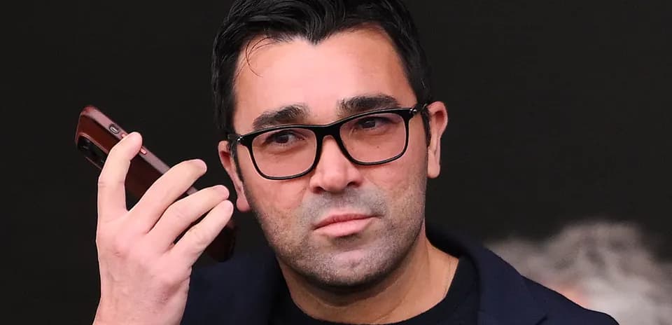 Person holding a phone and looking thoughtful