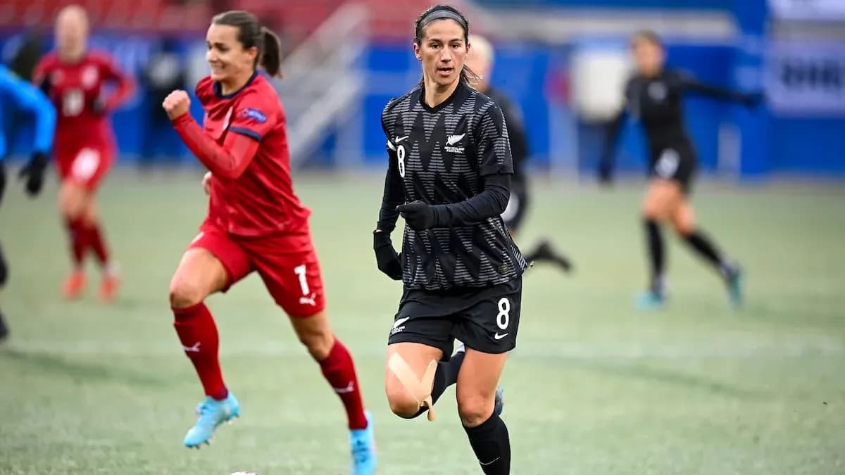 New Zealand player in black jersey running with ball