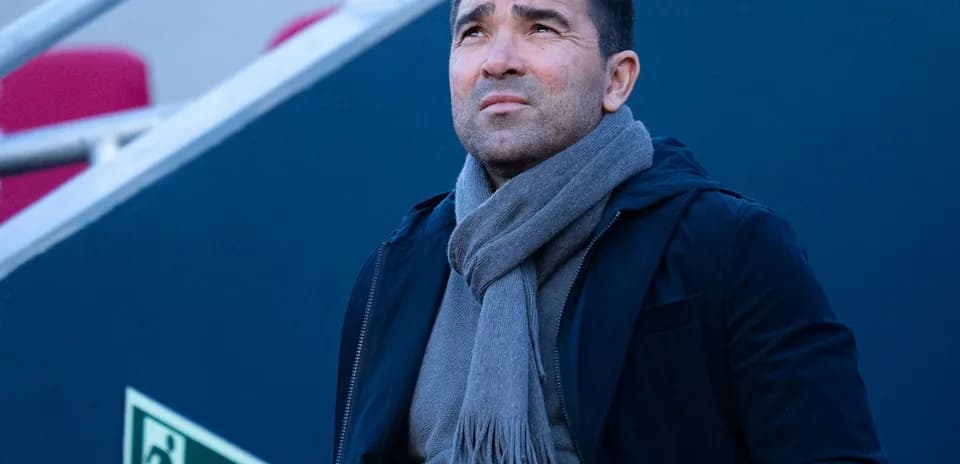 Coach looking up while wearing a scarf
