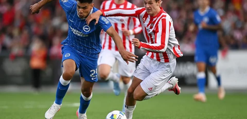 Two players competing for the ball during match