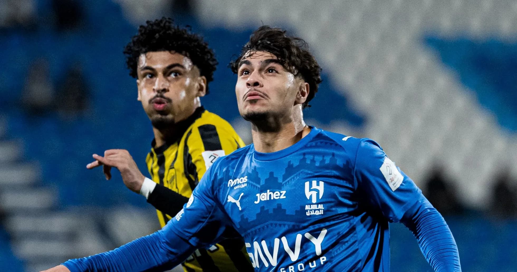 Two players in action during football match
