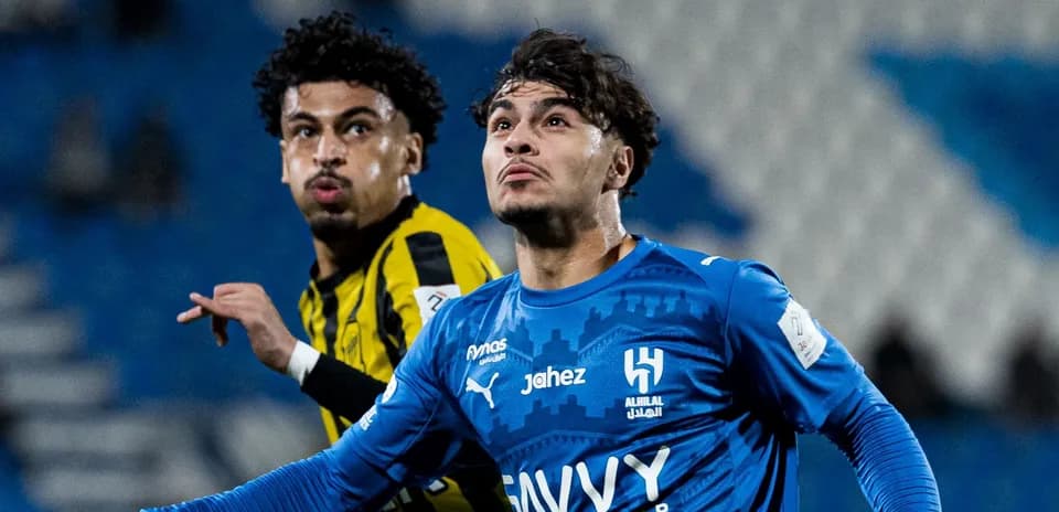 Two players in action during football match