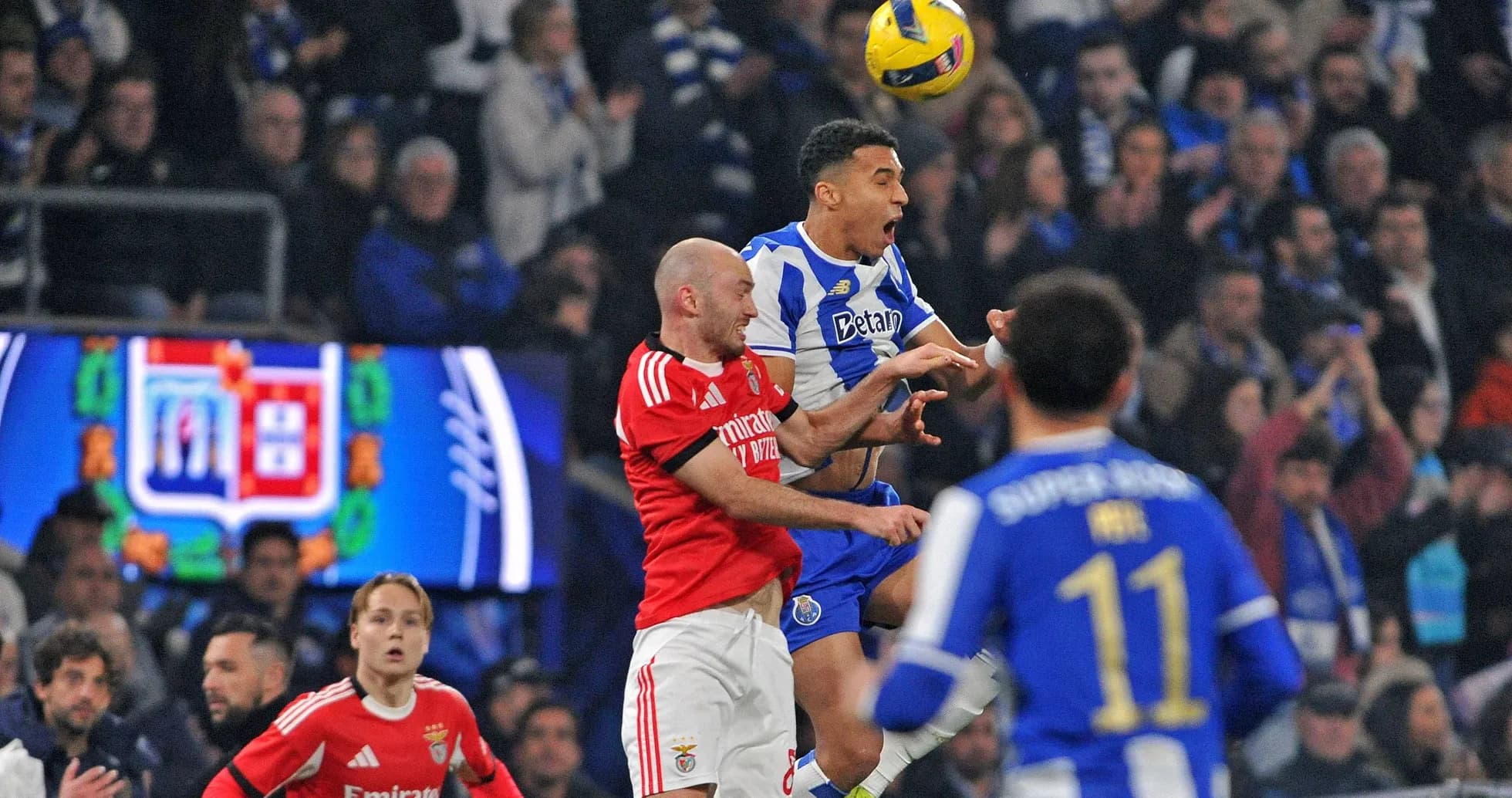 Porto player challenging Benfica player for the ball