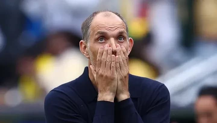 Football manager with hands on face during match