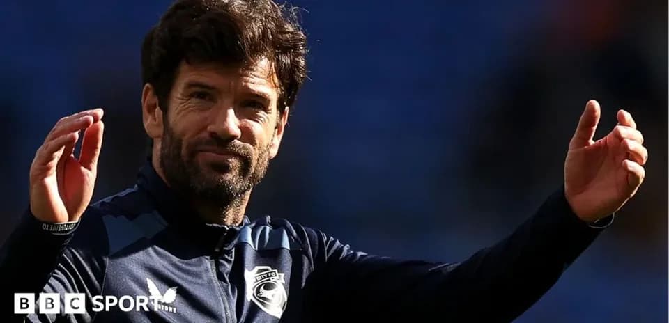 Football manager gesturing on the pitch