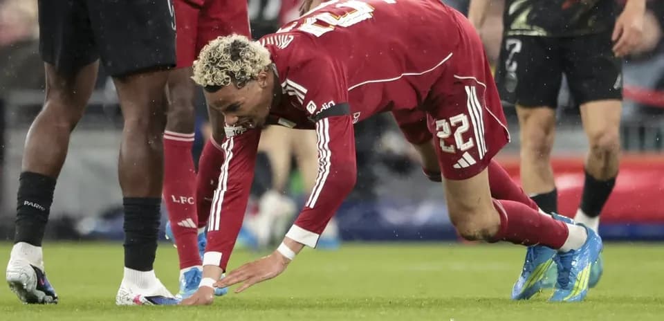 Player on the ground reaching for the ball