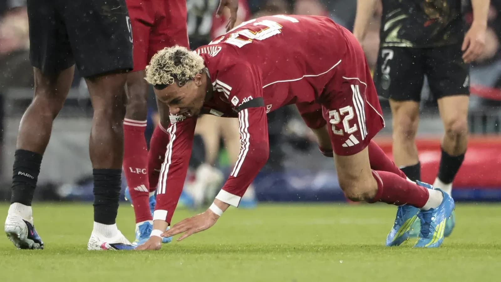 Player on the ground reaching for the ball