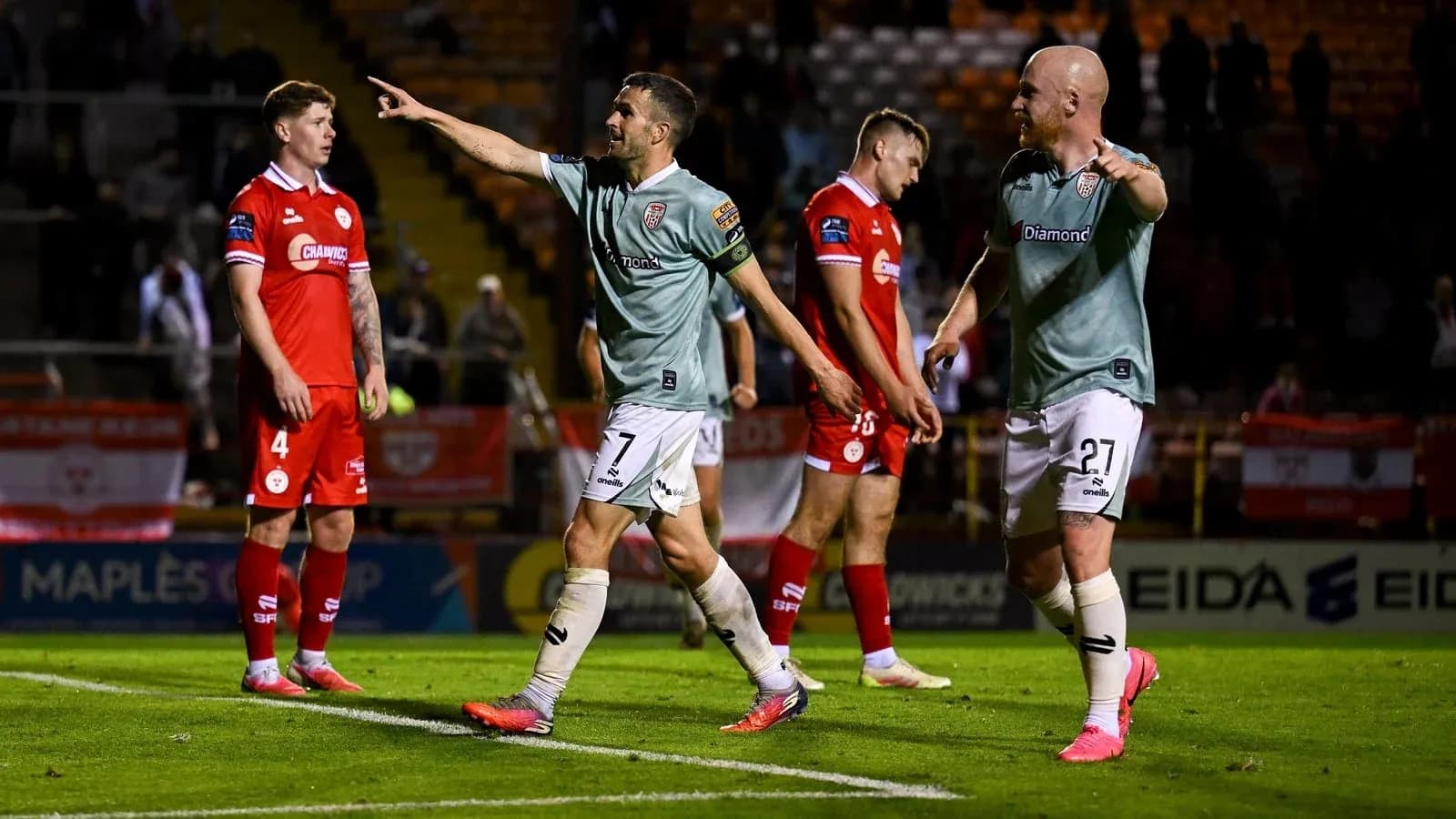 Players celebrating after a goal during match