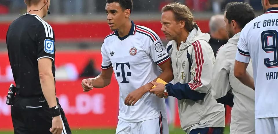 Bayern player receiving medical attention during match
