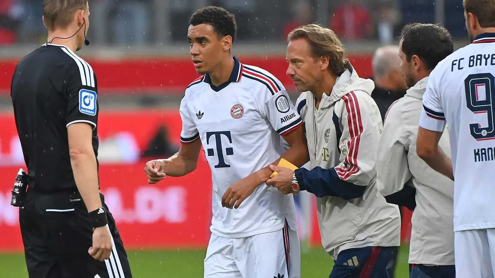 Bayern player receiving medical attention during match