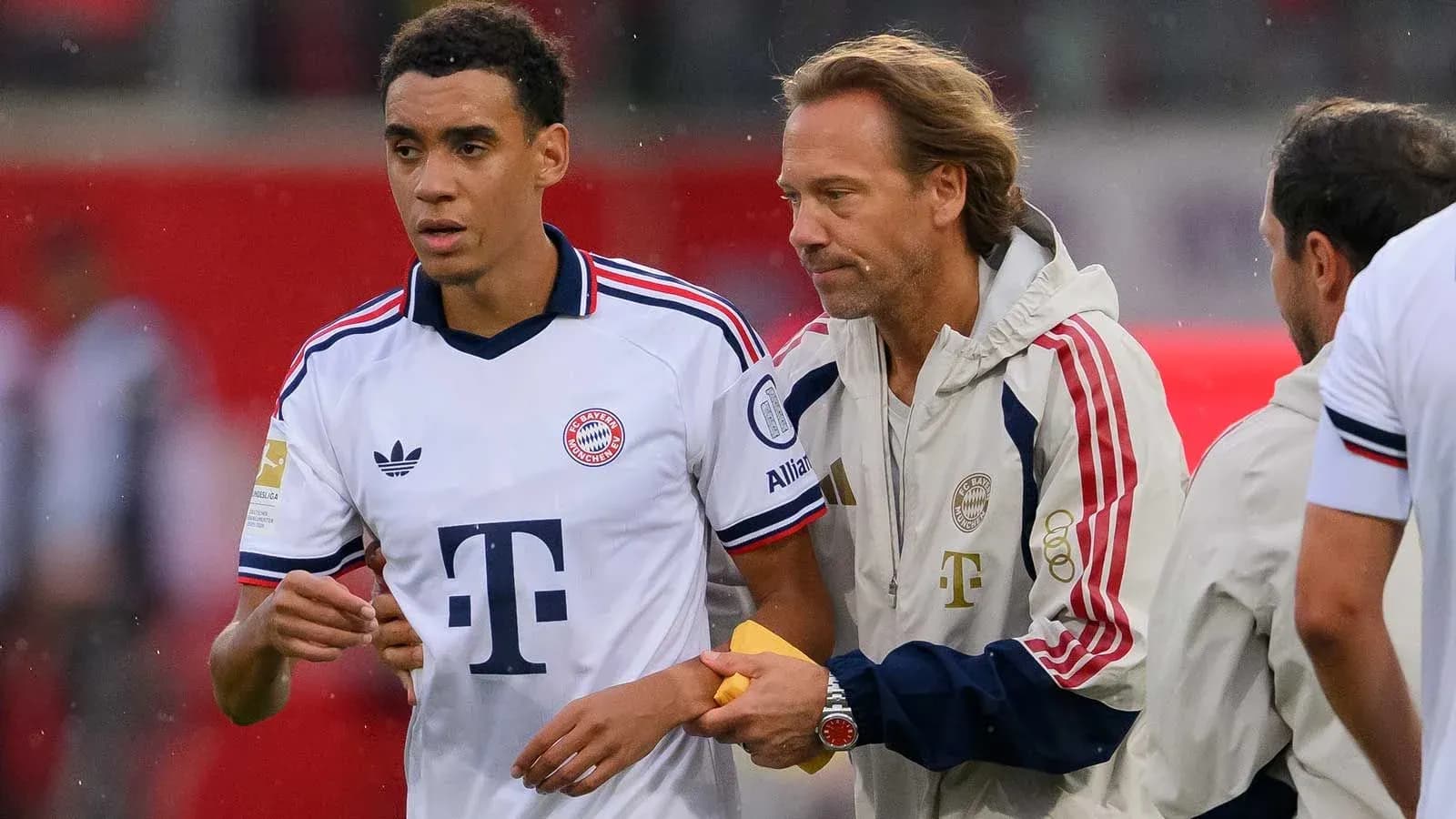 Bayern Munich players and staff discussing on pitch