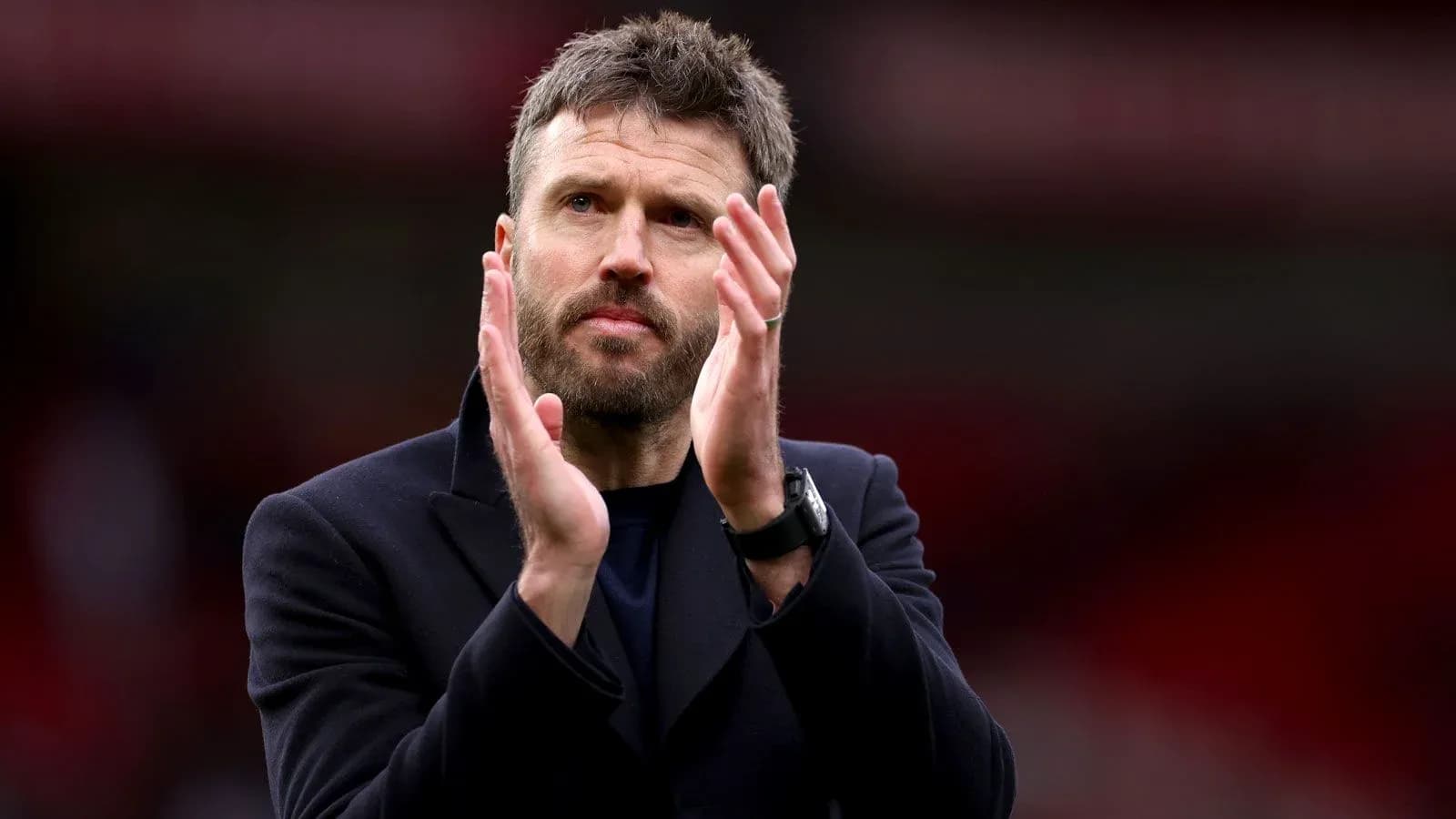 Coach applauding fans after match conclusion