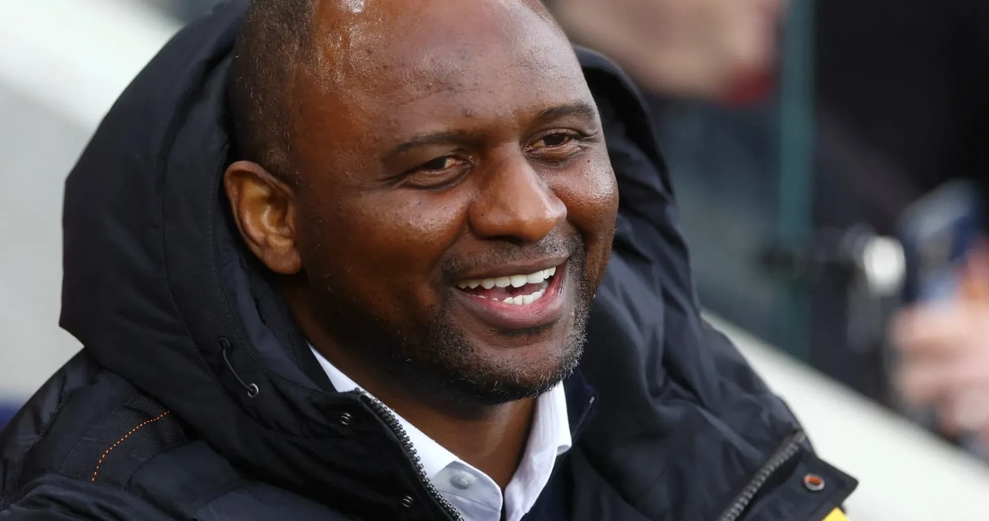 Patrick Vieira smiling in the stands during match