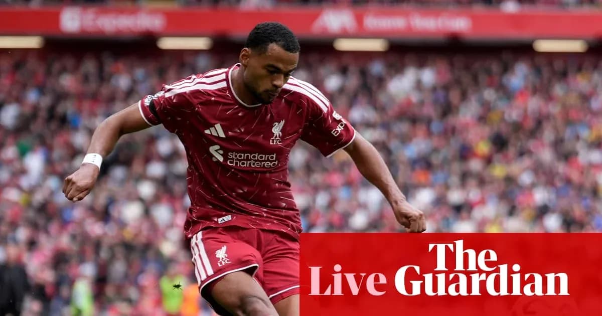 Liverpool player dribbling during match at Anfield