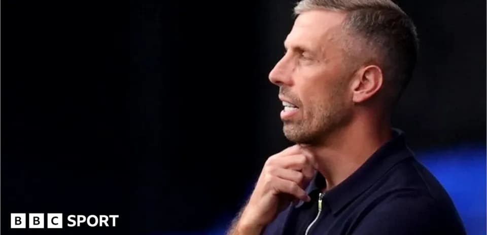 Men's football coach deep in thought during match