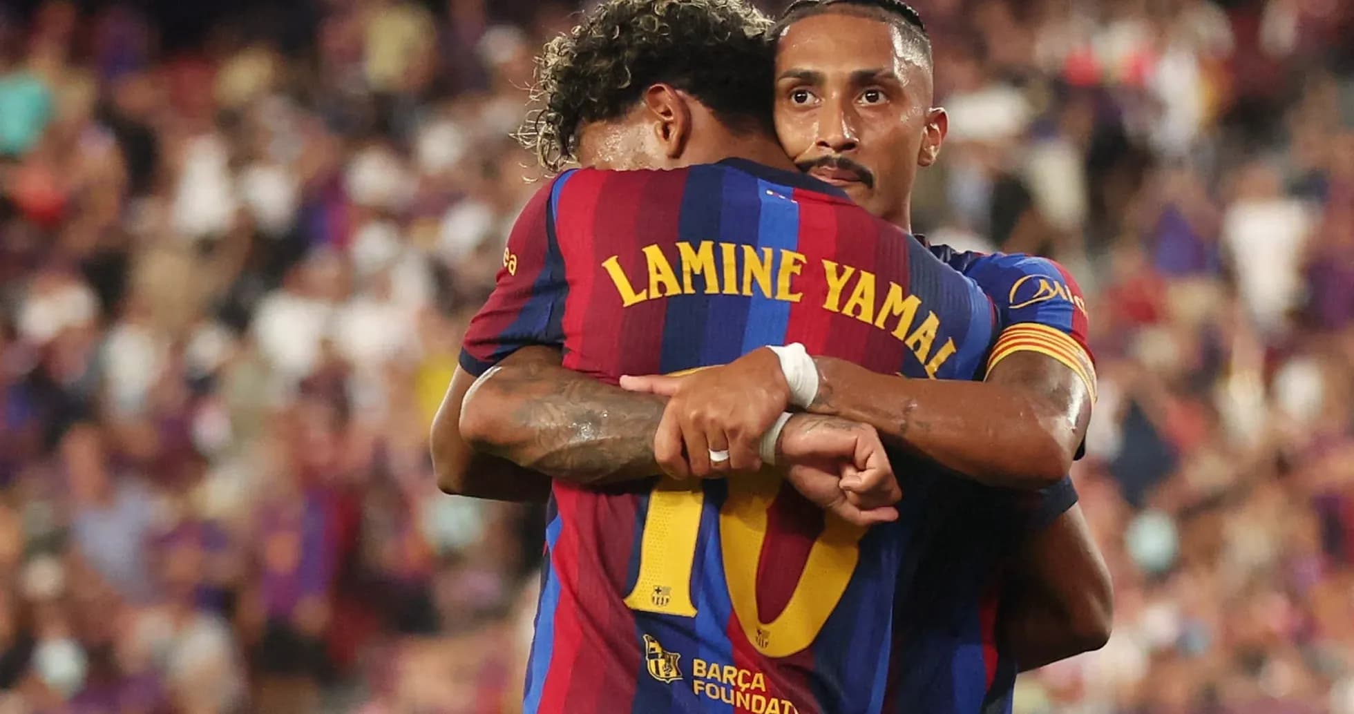 Barcelona players embracing on the pitch