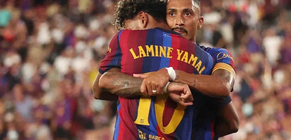 Barcelona players embracing on the pitch