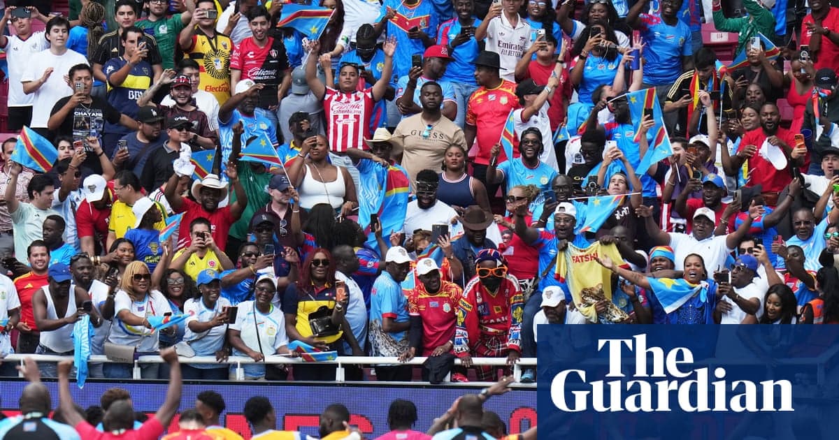 Crowd of fans waving flags at sports event
