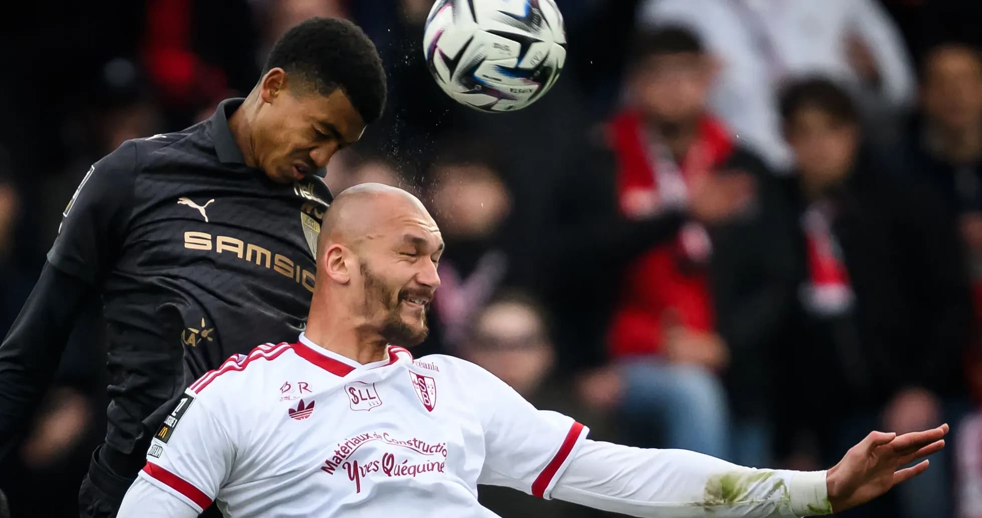 Two players contesting a header during match