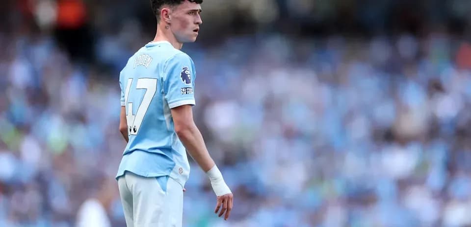 Phil Foden in Manchester City kit on the field
