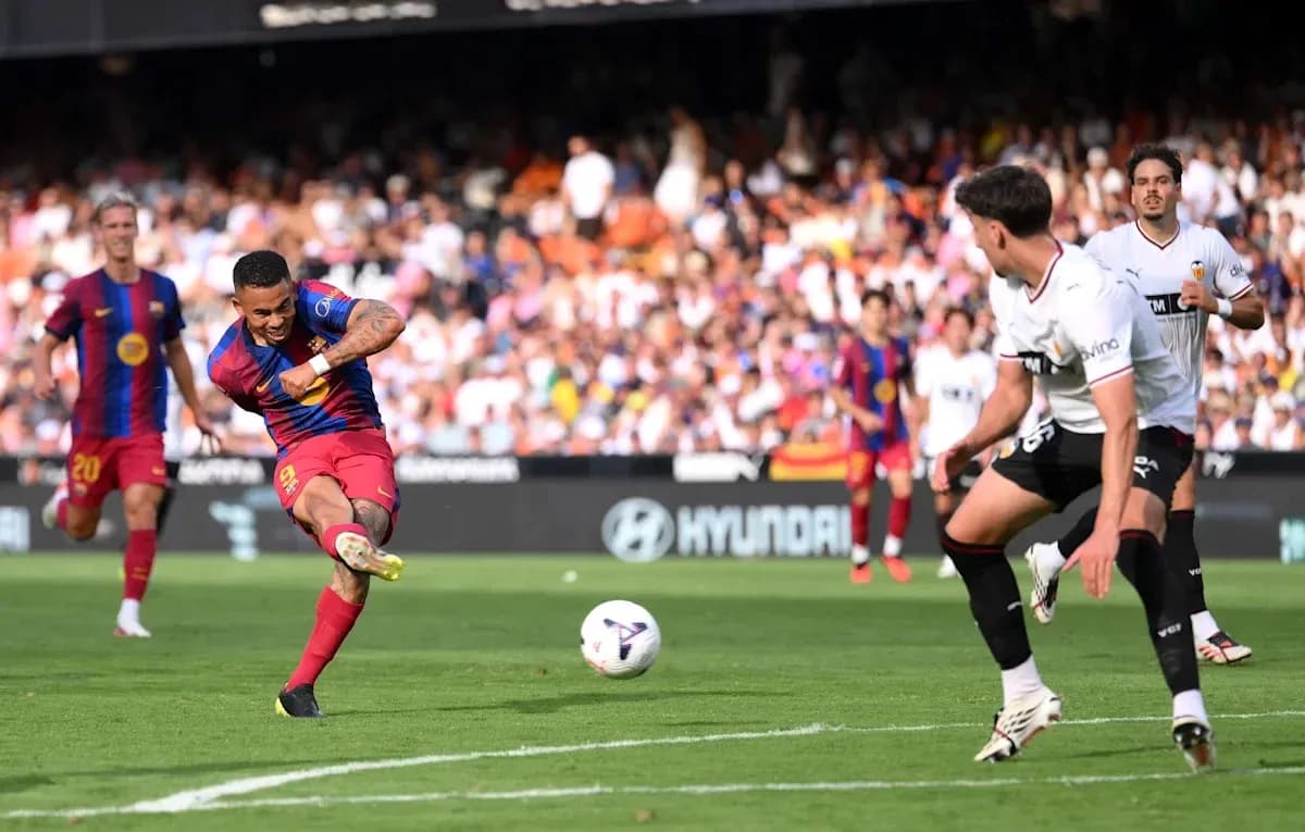 Barcelona player shooting the ball during match