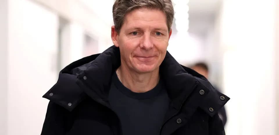 Man walking in a corridor wearing a jacket