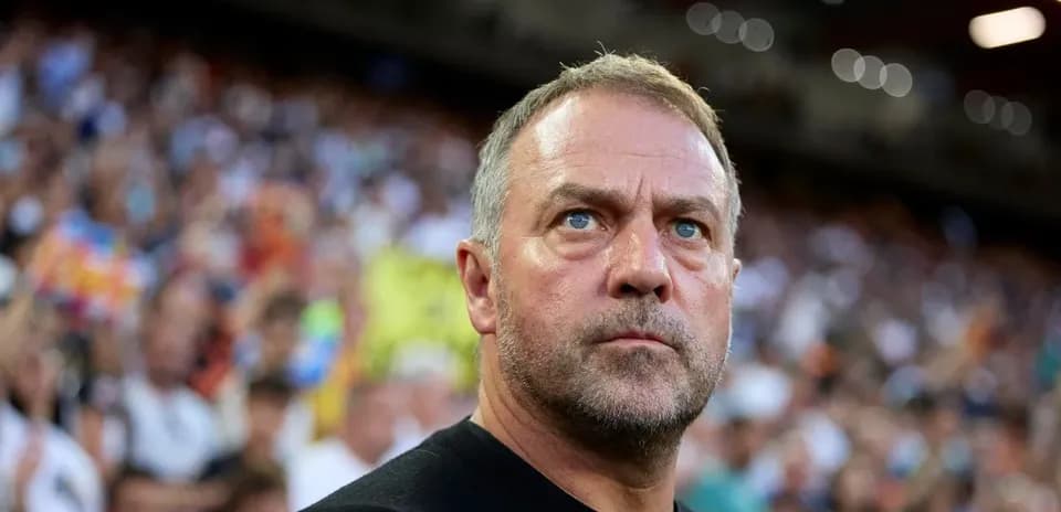 Coach observing match with focused expression in stadium