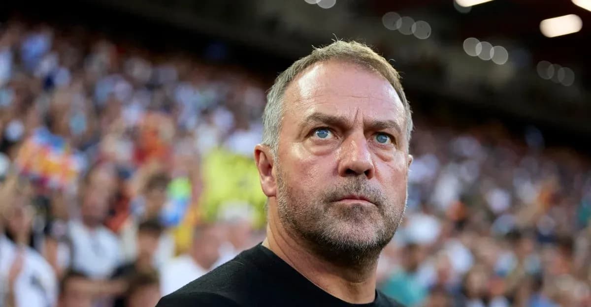 Coach observing match with focused expression in stadium