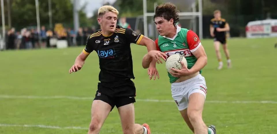 Two players competing for possession of the ball