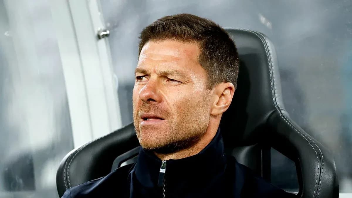 Coach seated on bench during a match