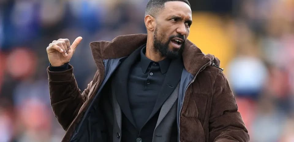Coach gesturing during a match on the sideline