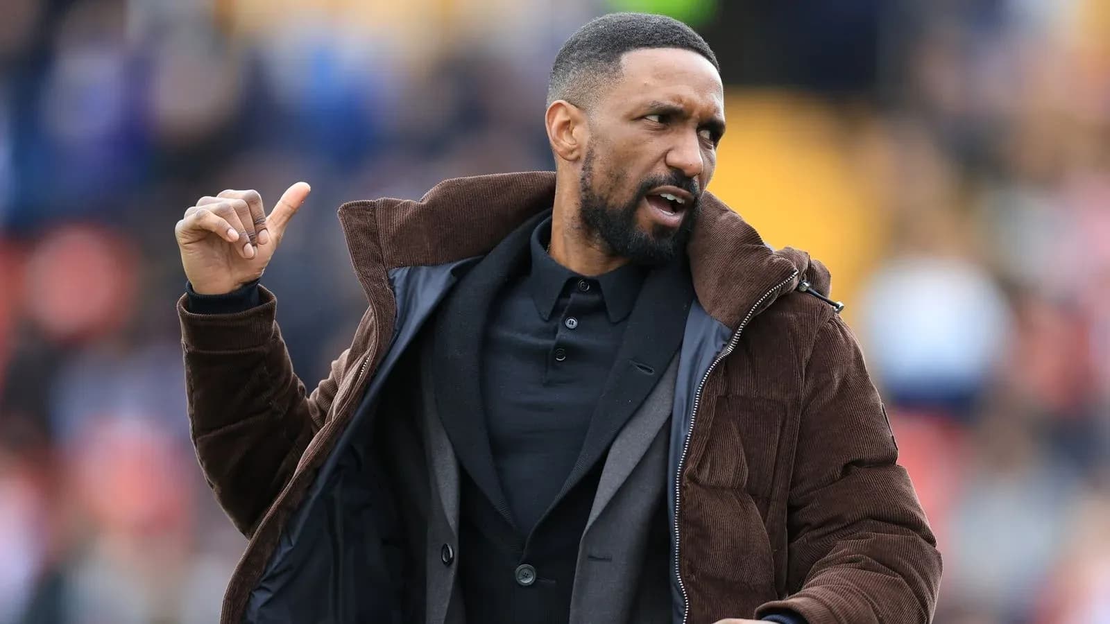 Coach gesturing during a match on the sideline