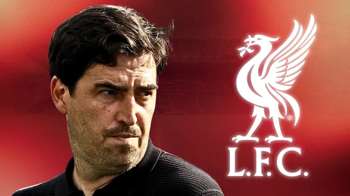 Football coach in front of Liverpool logo