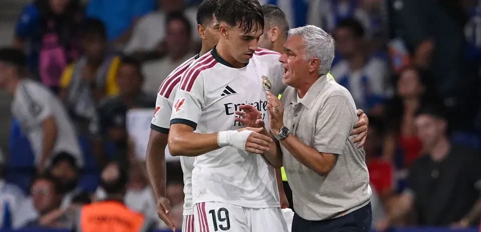 Real Madrid player receiving instructions from coach