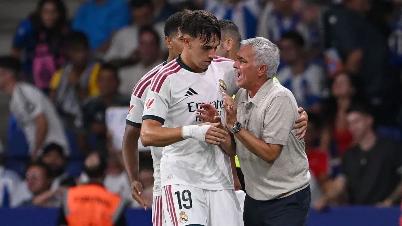 Real Madrid player receiving instructions from coach