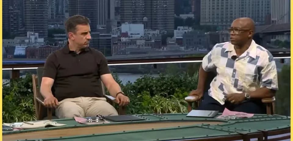Two analysts discussing at a sports studio table