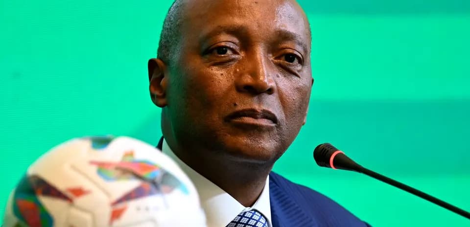 Official at press conference with football in foreground