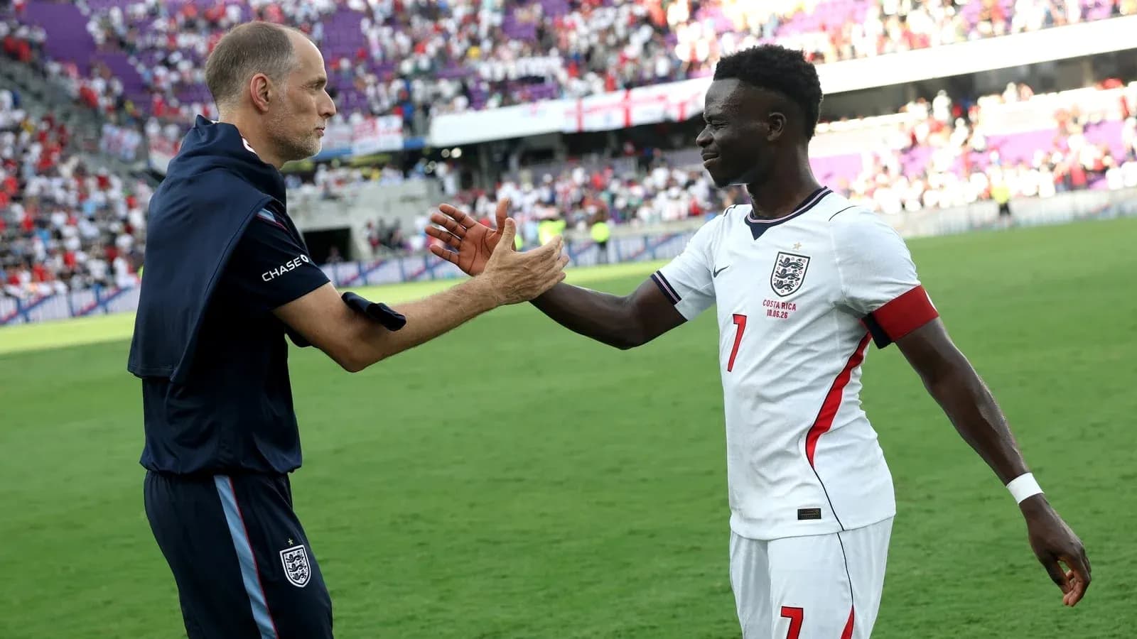 Coach and player shaking hands on the field