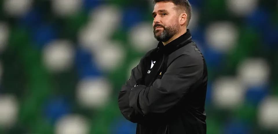 Football manager observing the game from the sidelines
