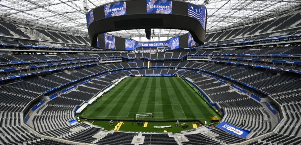 Empty stadium with field and large screens