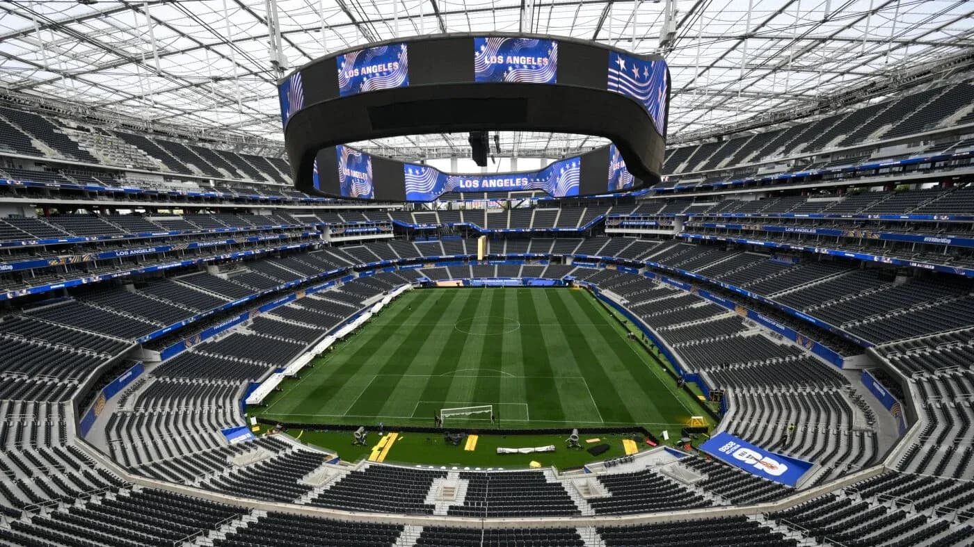 Empty stadium with field and large screens