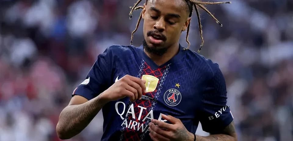 PSG player adjusting his medal after match