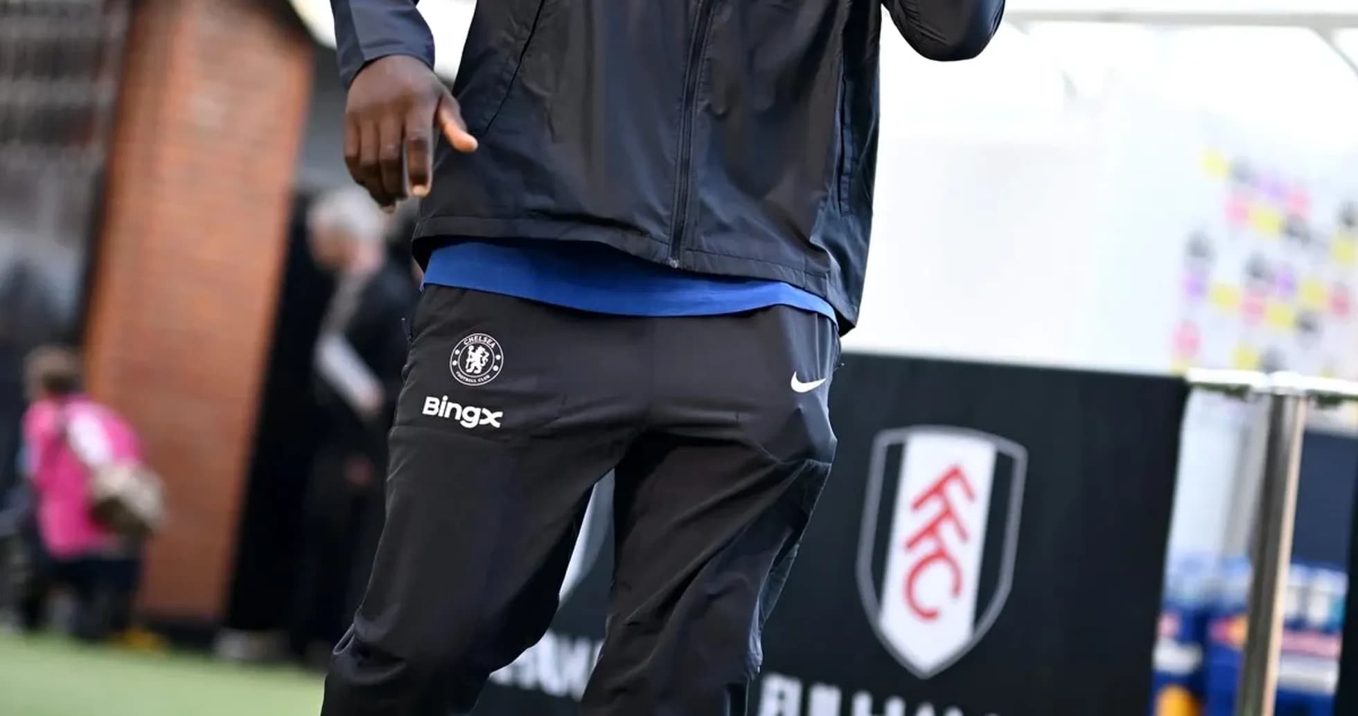 Player in Chelsea tracksuit walking before match