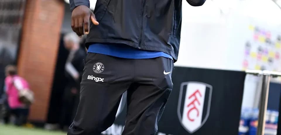 Player in Chelsea tracksuit walking before match