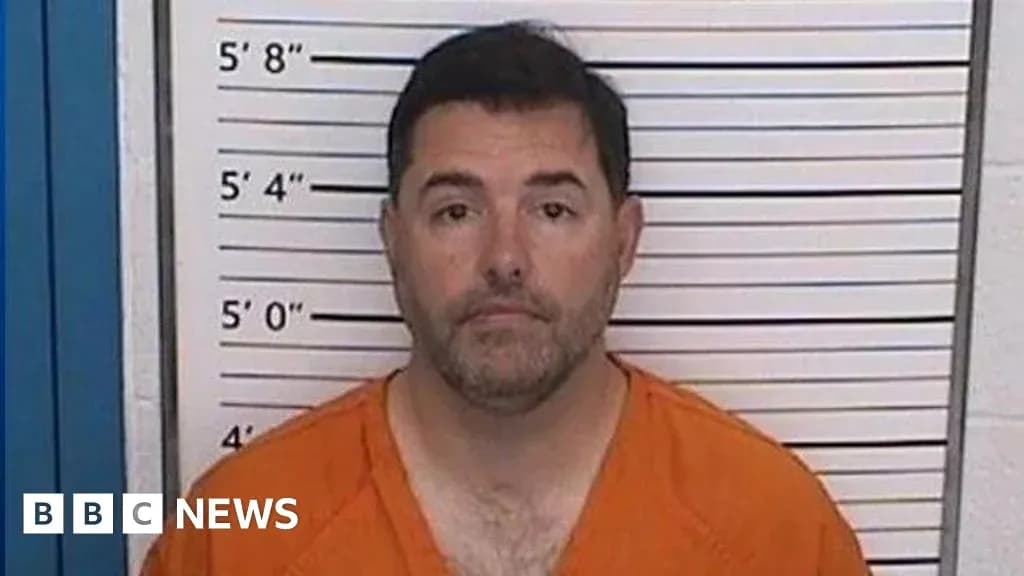 Mugshot of a man in orange jumpsuit