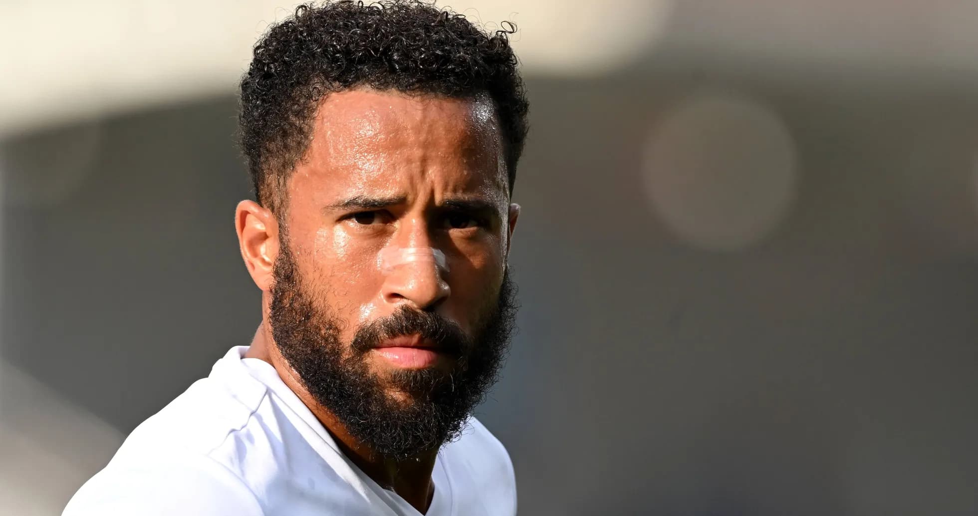 Player with beard and curly hair looking intently